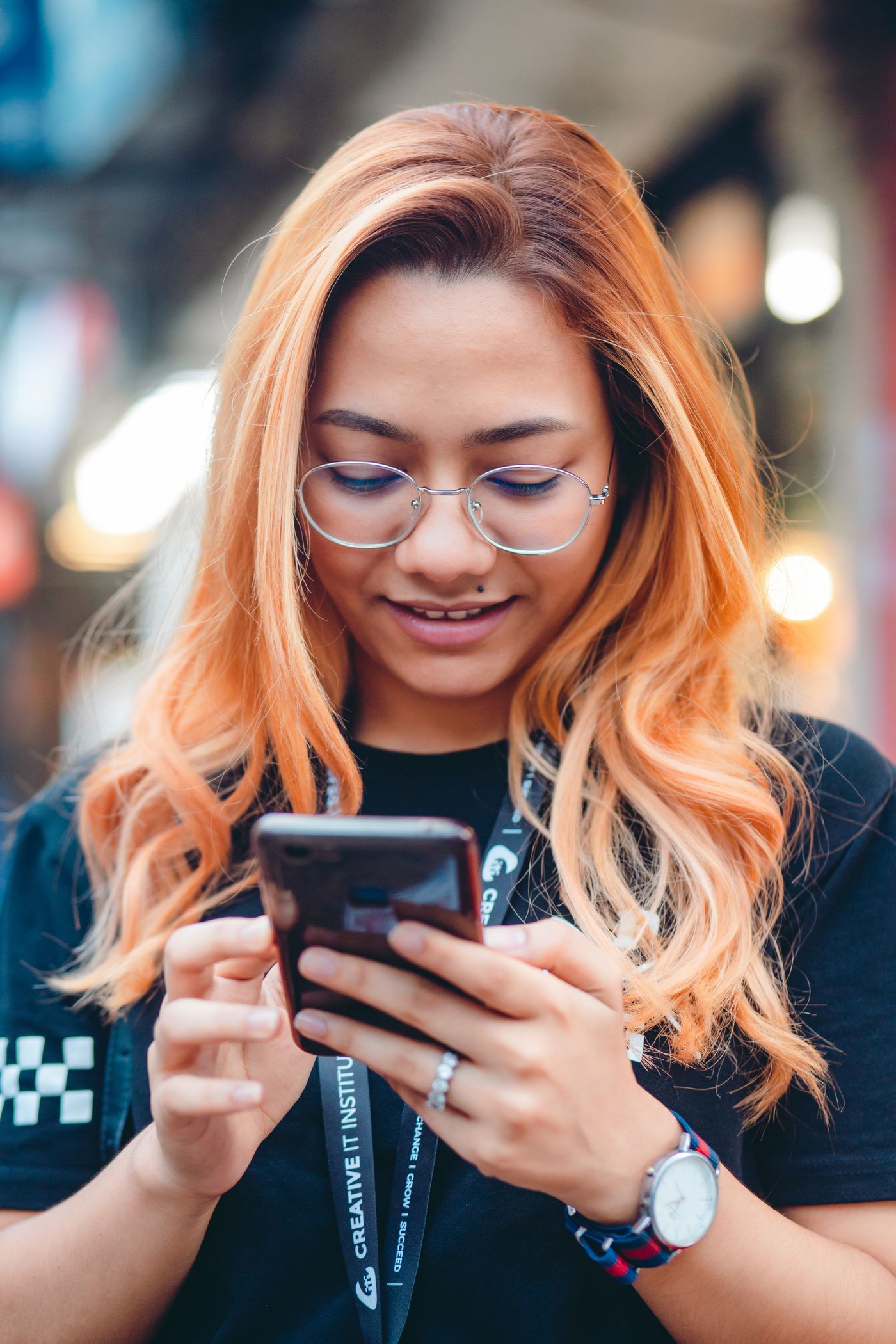A woman using her smartphone outdoors in Dhaka, Bangladesh